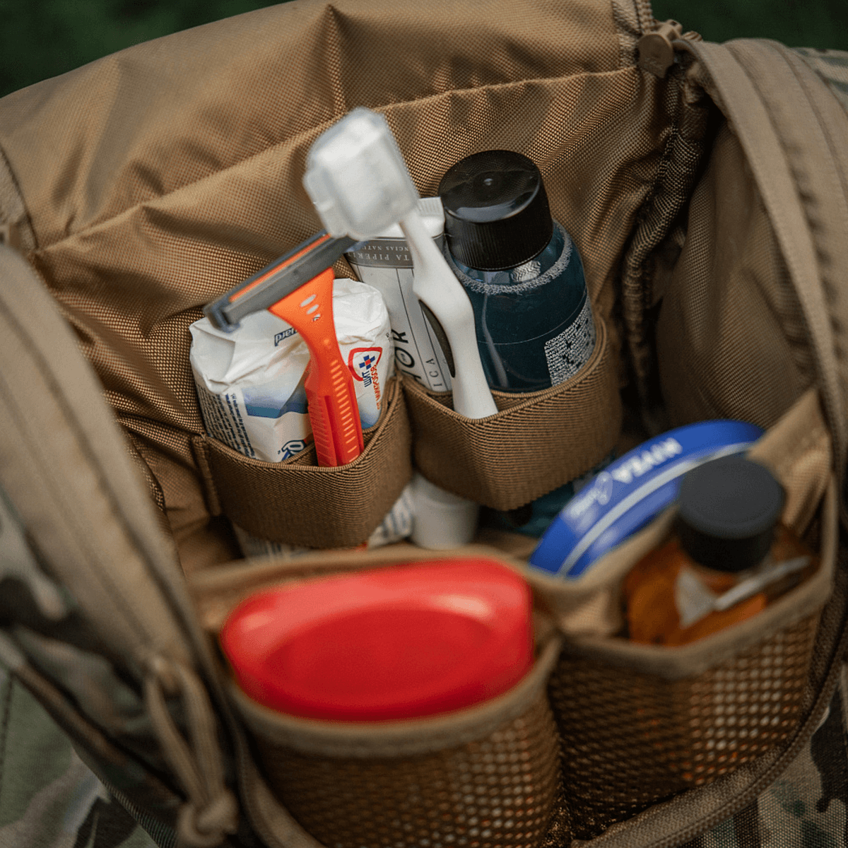 M-Tac Toilettaske Elite Gen.II fyldt med hygiejneartikler som tandbørste, tandpasta, shampoo og lotion, perfekt til rejsebrug.