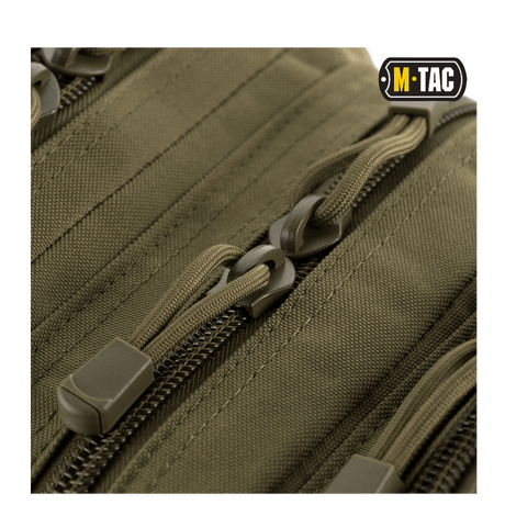 Nærbillede af lynlåse på M-Tac Assault Pack med MOLLE-system og polstrede skulderremme.