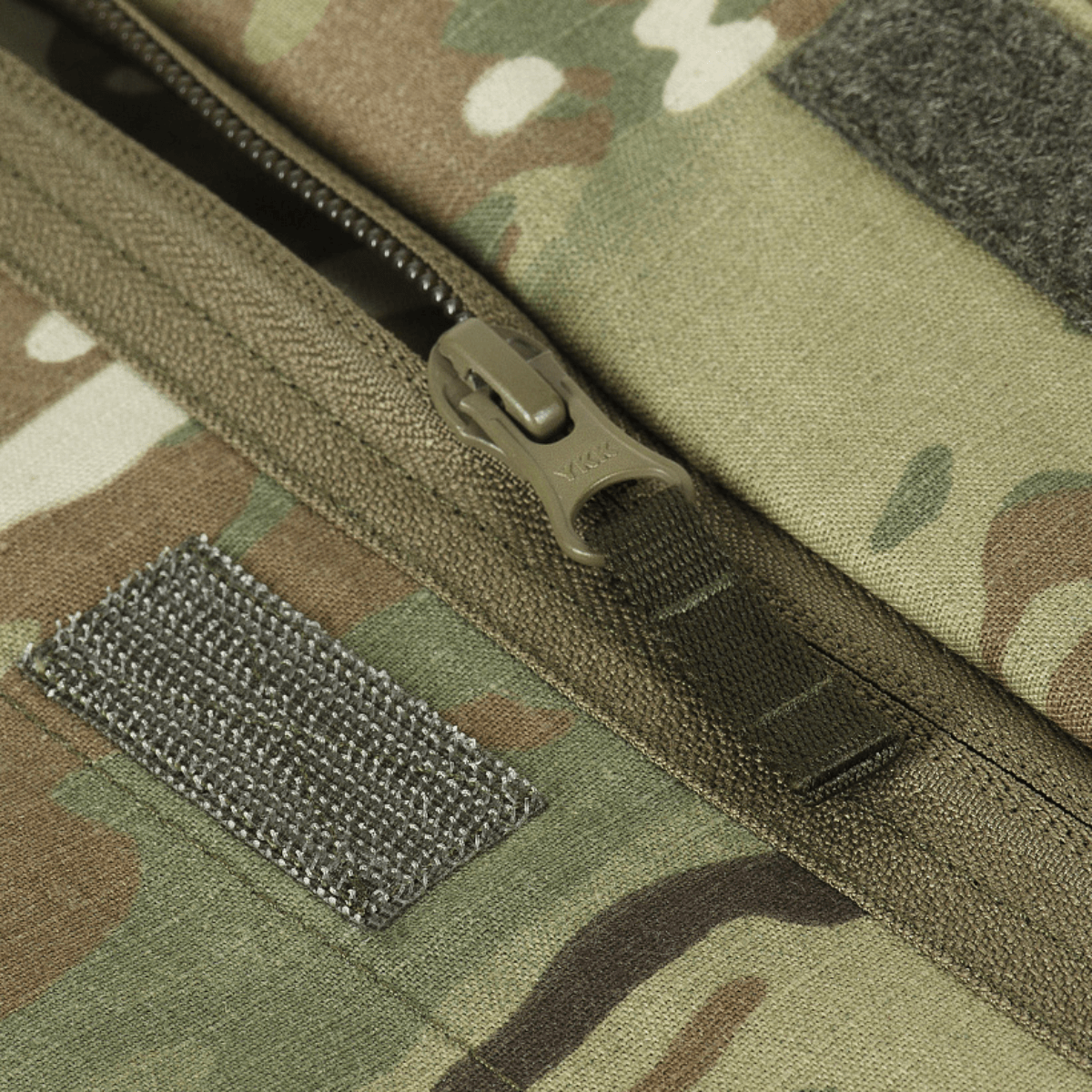 Close-up of M-Tac Jakke Sturm NYCO Extreme with YKK zipper in Multicam pattern, showing durable fabric and quality stitching details.