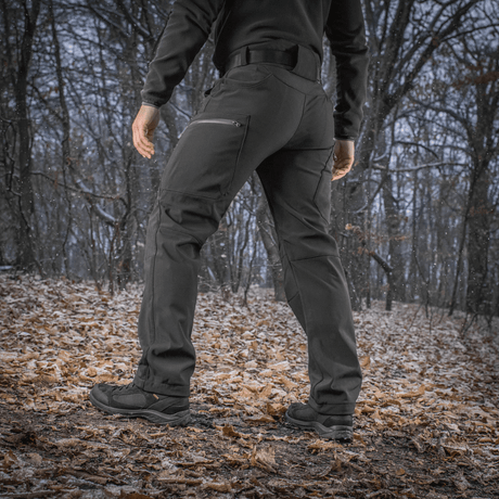 M-Tac Bukser Soft Shell Vinter i skovmiljø, ideelle til vinterbrug med fleecefor og vind- og vandafvisende softshell-materiale.