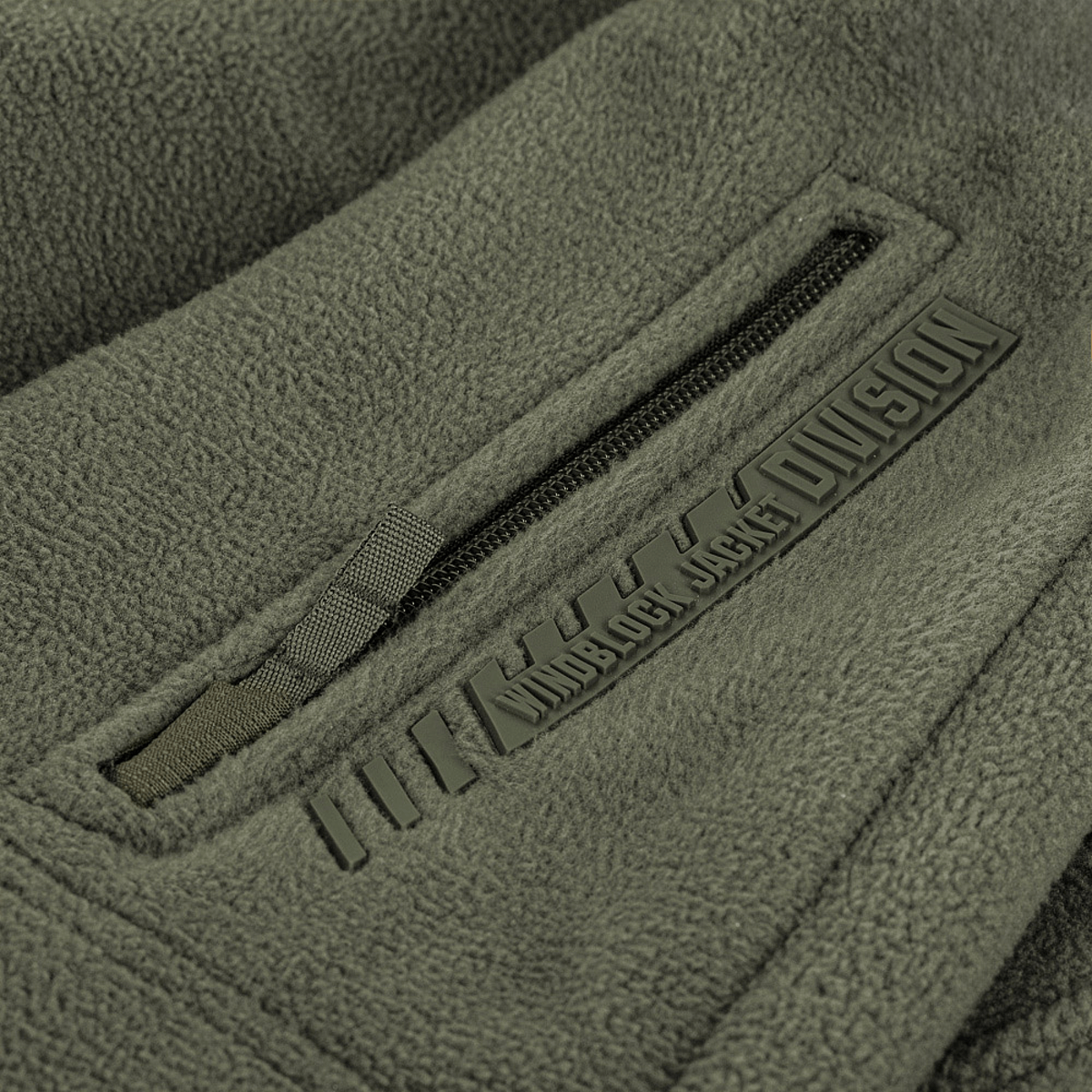 M-Tac Division Gen.II Windblock Fleecejakke - detaljeret billede af lynlås og struktur, viser vindtæt materiale til varme og beskyttelse.