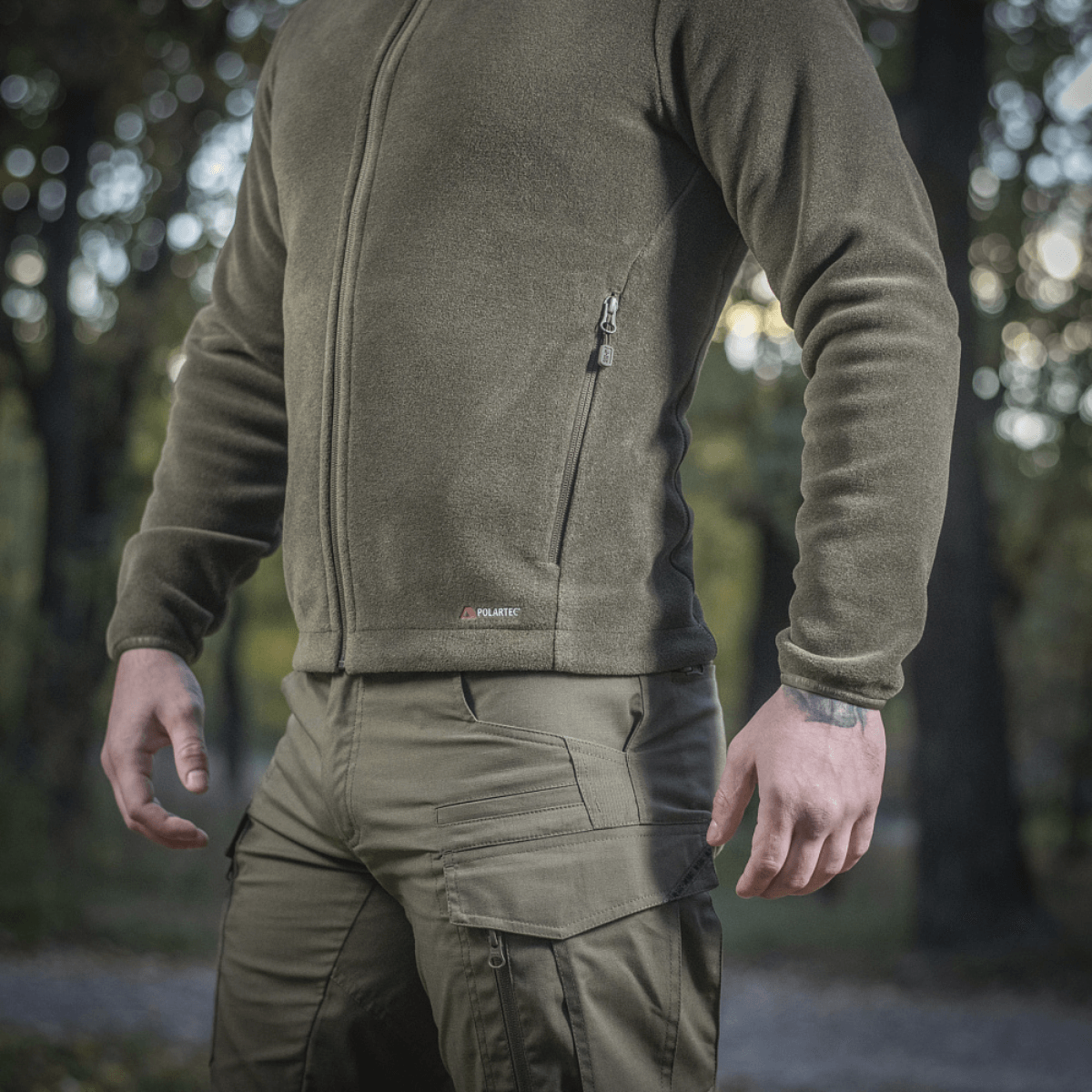Mand iført M-Tac Nord Polartec Fleecejakke i skov, viser stil og varmeisolering fra Polartec® 200 Series fleece, perfekt til aktiviteter.