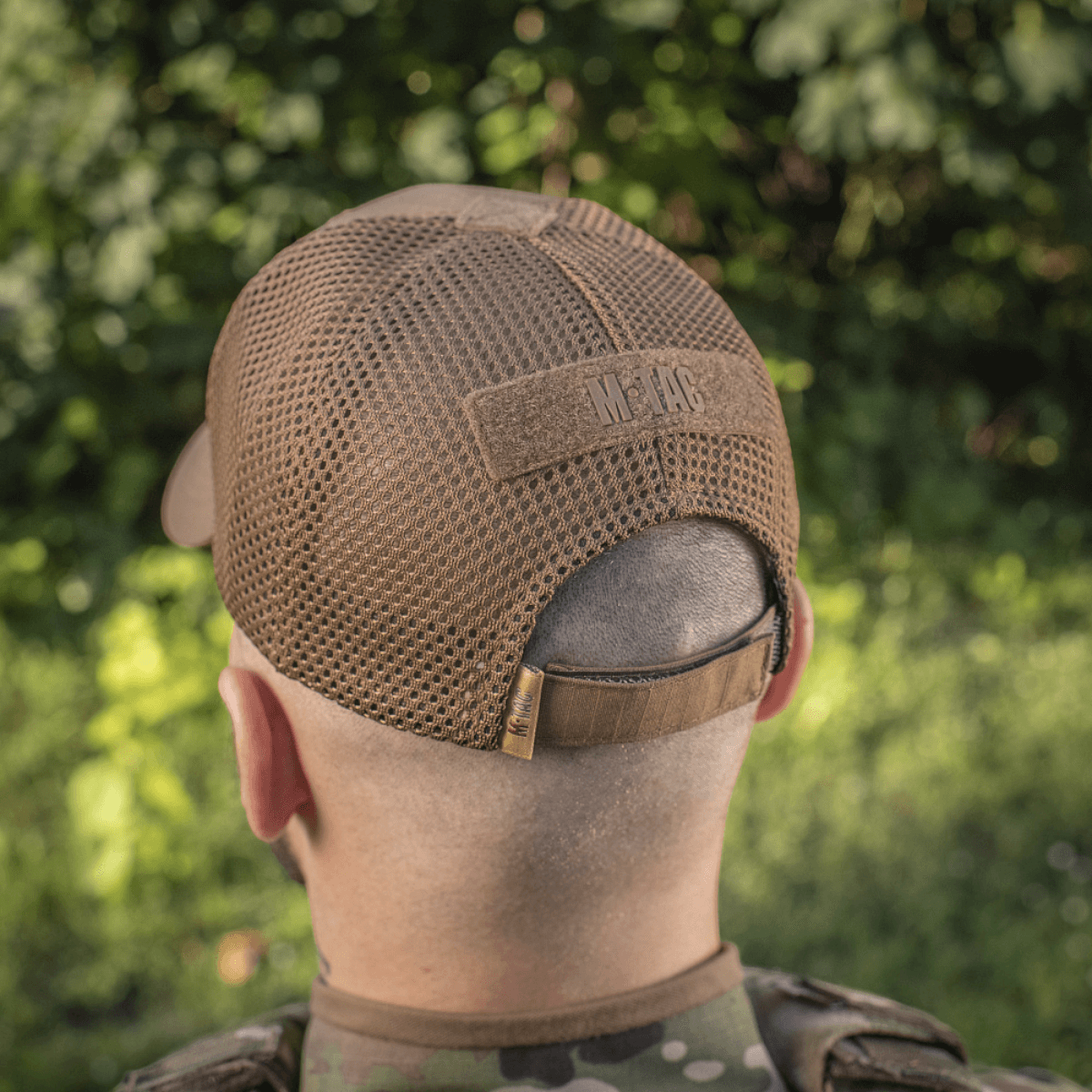 M-Tac Baseball Cap Ripstop Elite Flex i brun bagfra set på person udendørs med skovbaggrund