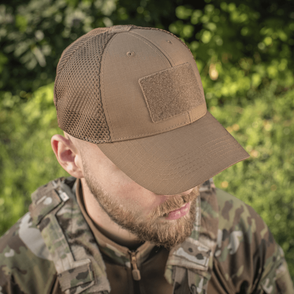 M-Tac Baseball Cap Ripstop Elite Flex på en person i camouflagetøj. Stærk og komfortabel hat ideel til udendørs brug.