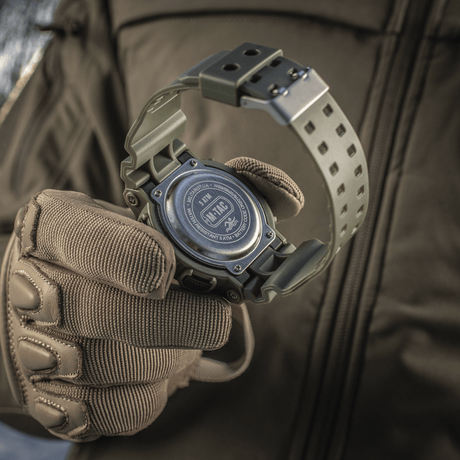M-Tac Sport Ur med robust design og vandafvisende funktion, perfekt til outdoor-aktiviteter og sport, vist på en taktisk handske.