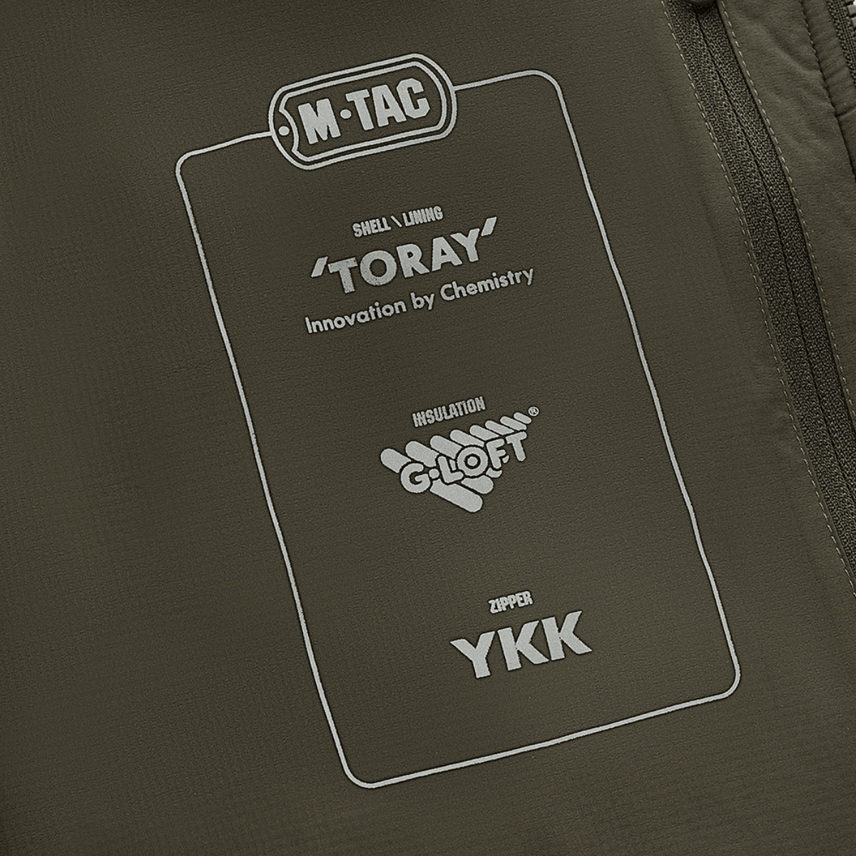 Detalje af M-Tac Paladin Jakke med Toray materiale, G-Loft isolering og YKK lynlås, der fremhæver kvaliteten af jakken.