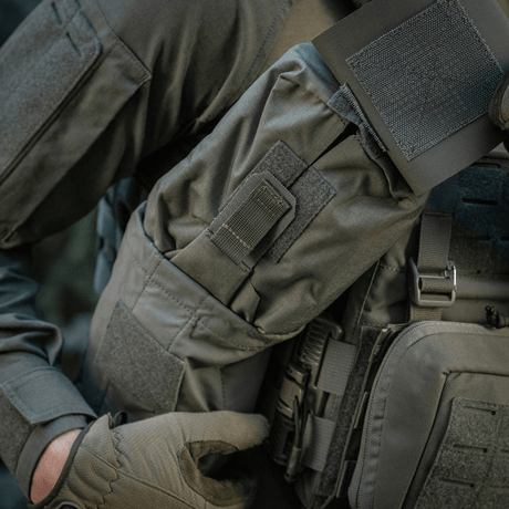 Person wearing a tactical vest with M-Tac Medic Pouch Vertical Large Elite attached, showcasing outdoor gear durability and functionality.