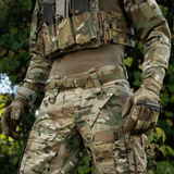 Person wearing M‑Tac Internal Tiger Bælte with tactical gear in camouflage setting