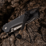 M-Tac Knife Lanyard Celtic flettet paracord lanyard med celtic design på sort kniv, stilfuldt tilbehør til knive og udstyr.