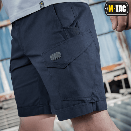 M-Tac Shorts Aggressor Short med taktiske lommer, ideel til bybrug og udendørs aktiviteter, vises i navy blå farve til mænd.