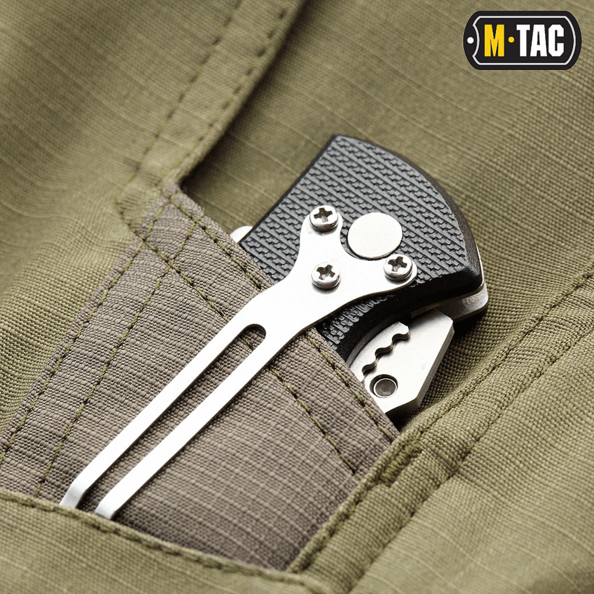 Close-up of a pocket on M-Tac Shorts Aggressor Short with a tactical tool inserted, showing durable fabric and stitching details.