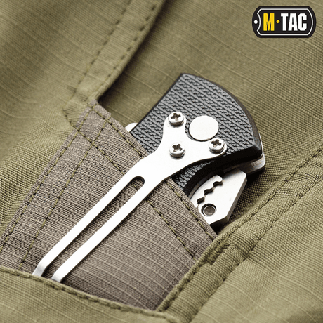 Close-up of a pocket on M-Tac Shorts Aggressor Short with a tactical tool inserted, showing durable fabric and stitching details.