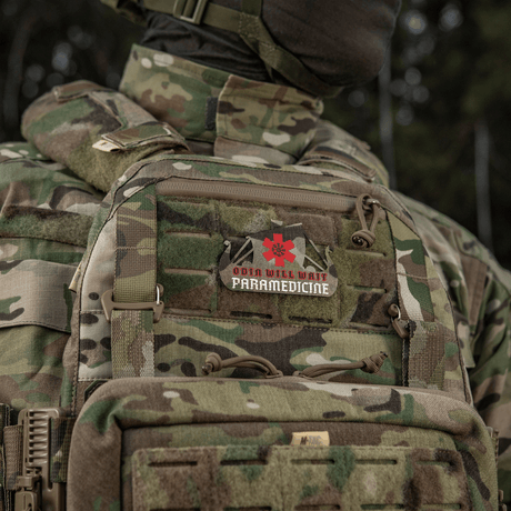 Camouflage uniform with paramedic patch displaying "Odin will wait Paramedicine" emblem