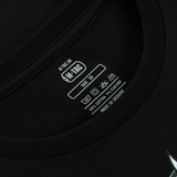 M-Tac T-Shirt Odin Mystery Long Sleeve etikettens nærbillede med vaskesymboler, lavet af bomuld og elastane, størrelse XS, sort farve.