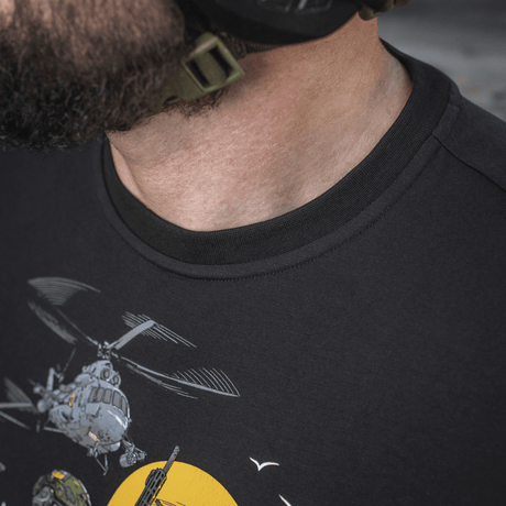 Mand iført M-Tac T-Shirt Surf Club, med design inspireret af ukrainske specialoperationer og surfscener, viser tæt på trykket.